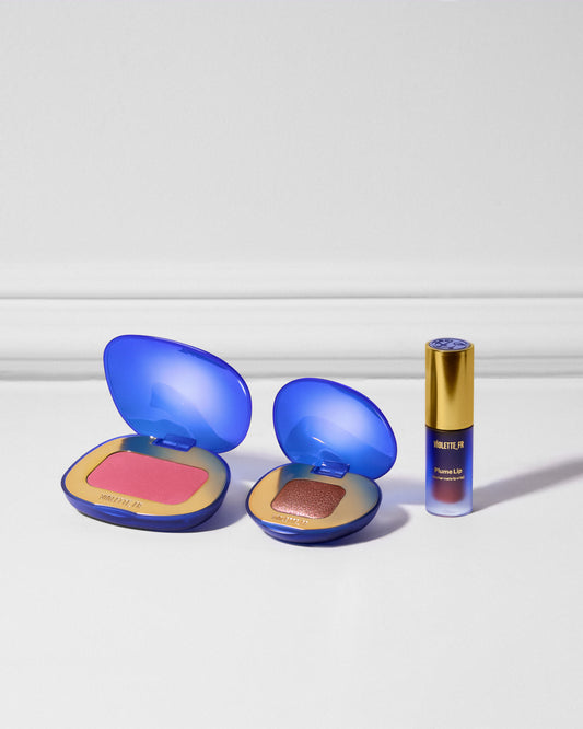 Three products lined up next to each other on a white moulding background. Blush, eyeshadow, and lipstick. - Plume Essentials Trio