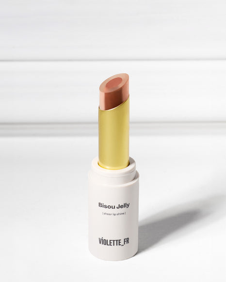 Violette_FR Bisou Jelly (sheer lip shine) in an open tube, showing its two-toned peachy-pink and brown-pink bullet.