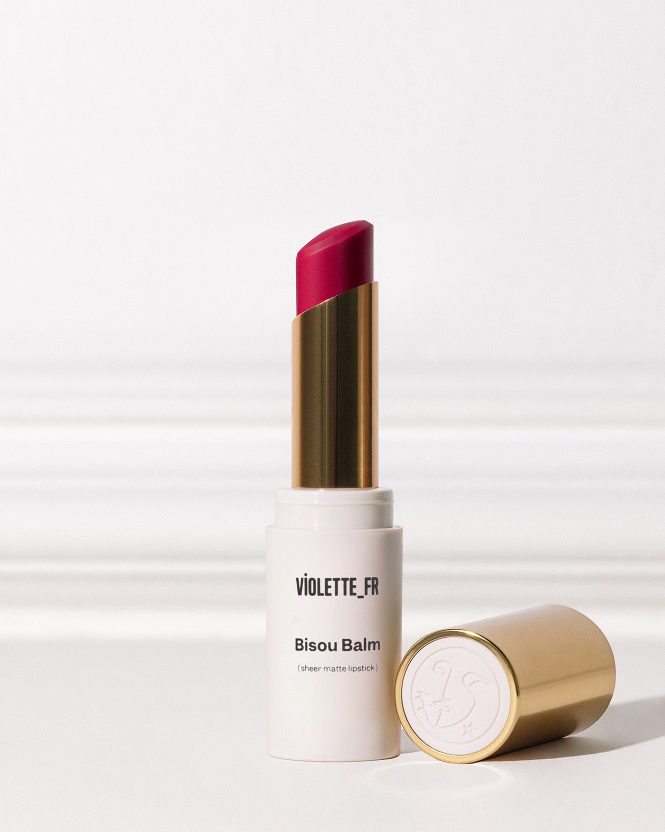 Bisou Balm - Bêtise - Bisou Balm (sheer matte lipstick) by VIOLETTE_FR. A fuchsia lipstick in a white and gold tube with its gold cap featuring a bird logo. - Image 121 of 121