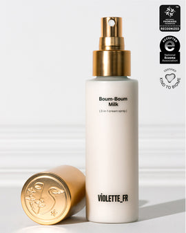 Violette_FR Boum-Boum Milk (3-in-1 cream spray) in a white bottle with a gold spray top and cap, recognized by the National Psoriasis Foundation, accepted by the National Eczema Association, and certified Kind to Biome.