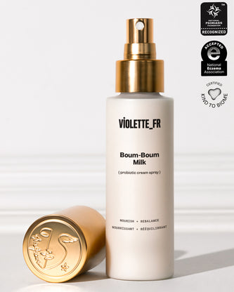 Violette_FR Boum-Boum Milk (3-in-1 cream spray) in a white bottle with a gold spray top and cap, recognized by the National Psoriasis Foundation, accepted by the National Eczema Association, and certified Kind to Biome.