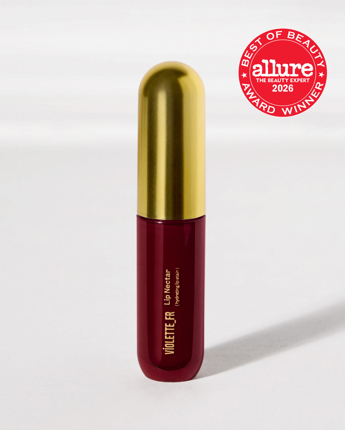 Lip Nectar - Bêtise - VIOLETTE_FR Lip Nectar (hydrating lip stain) in a dark red tube with a gold cap, awarded 'Allure Best of Beauty 2026 Award Winner'. - Image 19 of 19
