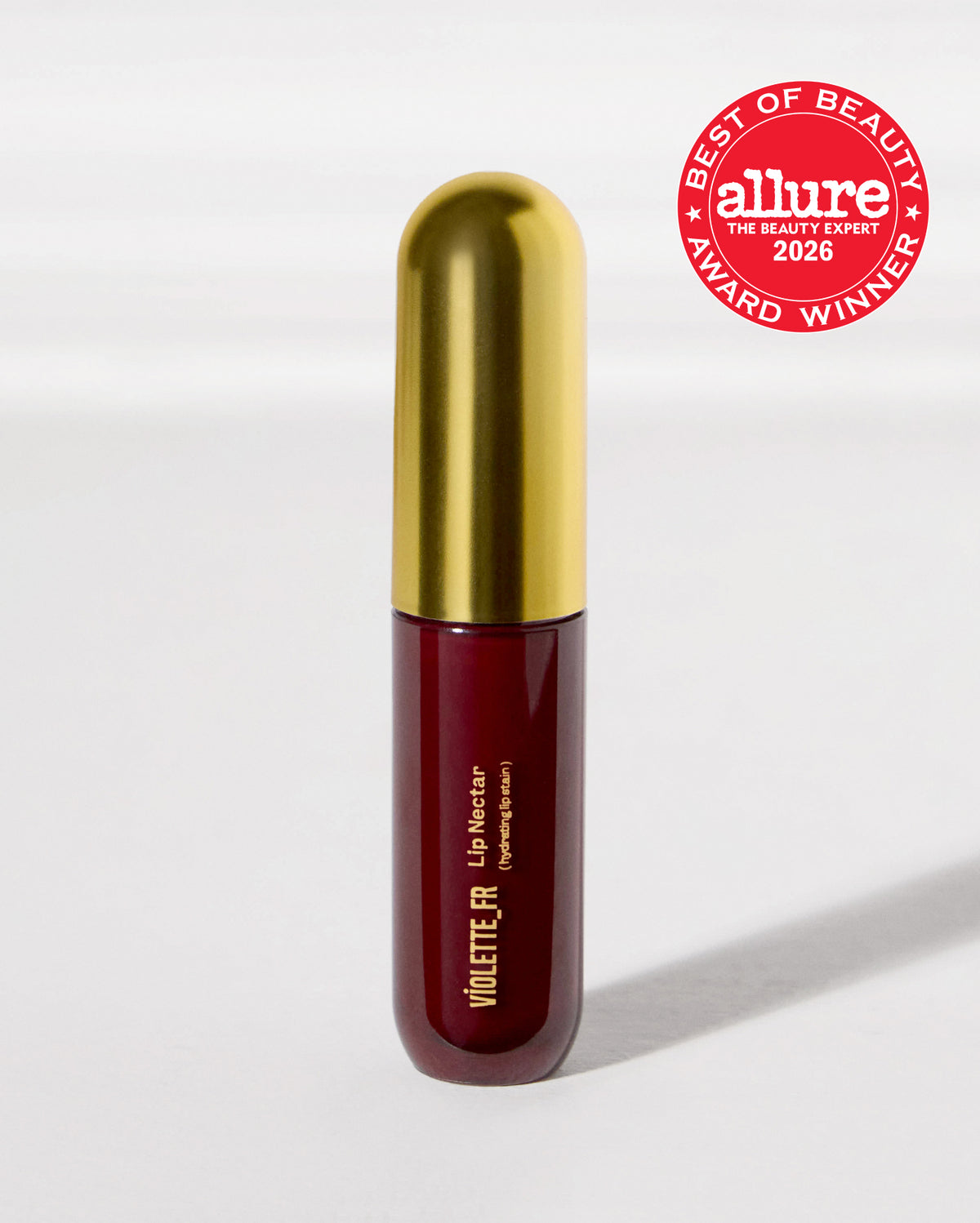 Violette_FR Lip Nectar (hydrating lip stain) in a deep red bottle with a gold cap. It is an 'Allure Best of Beauty 2026 Award Winner'.