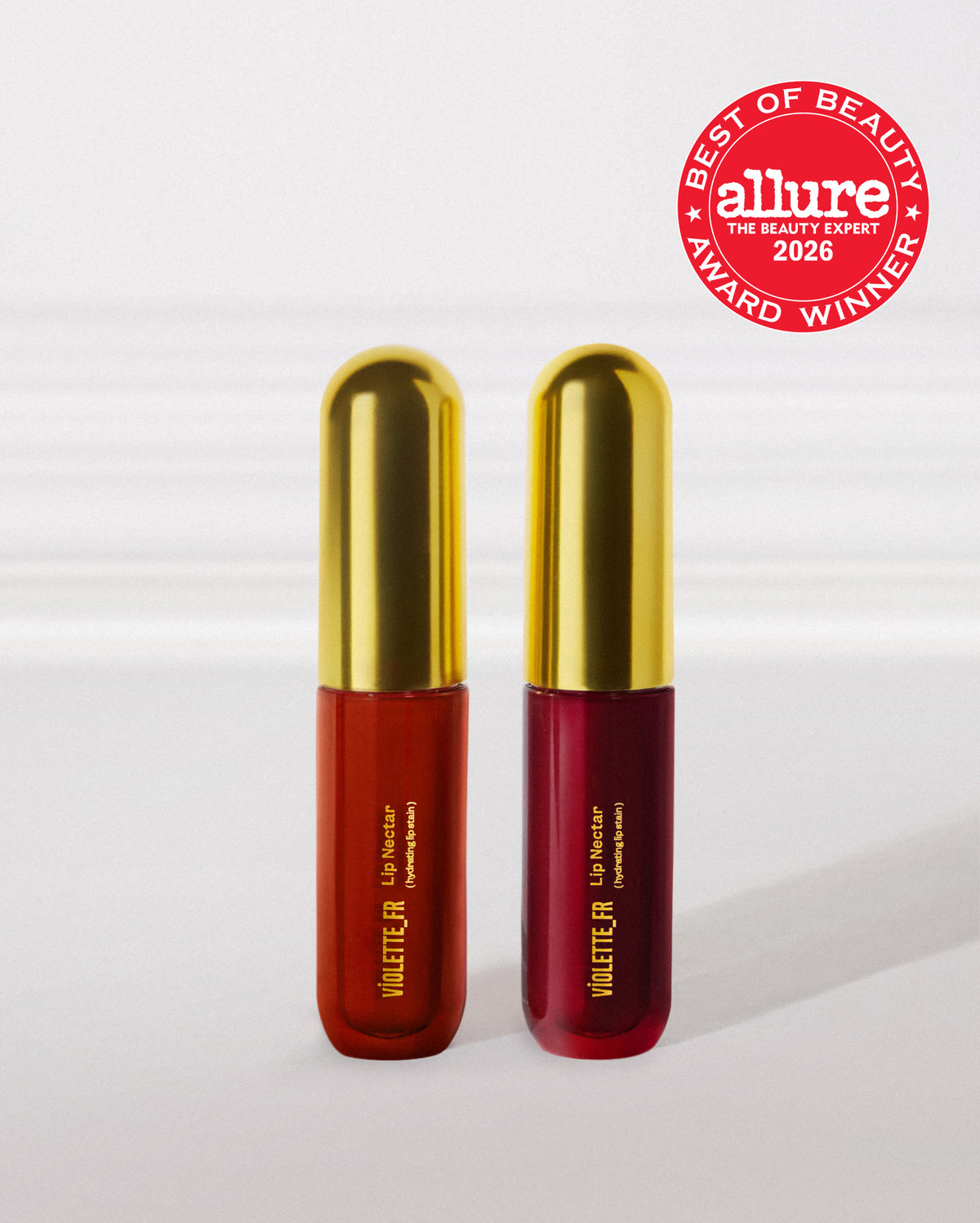 Two products, both 'VIOLETTE_FR Lip Nectar (hydrating lip stain)', one reddish-orange and one deep berry, with gold caps. An Allure Best of Beauty 2026 Award Winner badge is shown, reading 'BEST OF BEAUTY allure THE BEAUTY EXPERT 2025 AWARD WINNER'. - Lip Nectar Duo